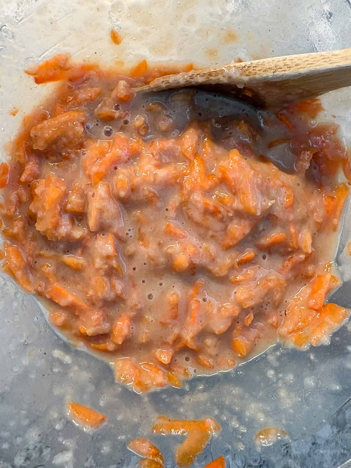 Mixed shredded carrots into wet ingredients.