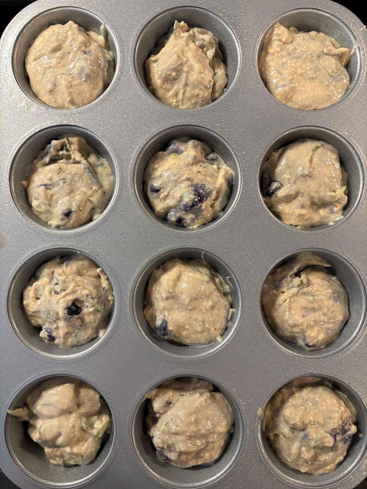 Batter divided into 12 muffin cups.