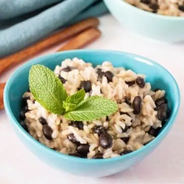 Small bowl of rice and beans, garnished with mint.