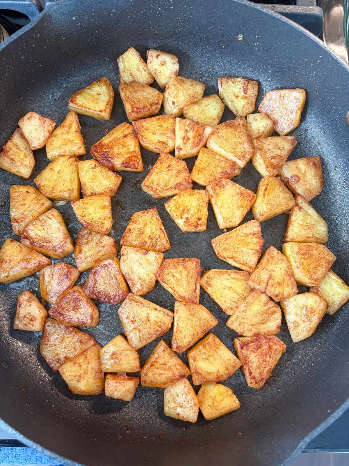 Caramelized pineapple in a pan.