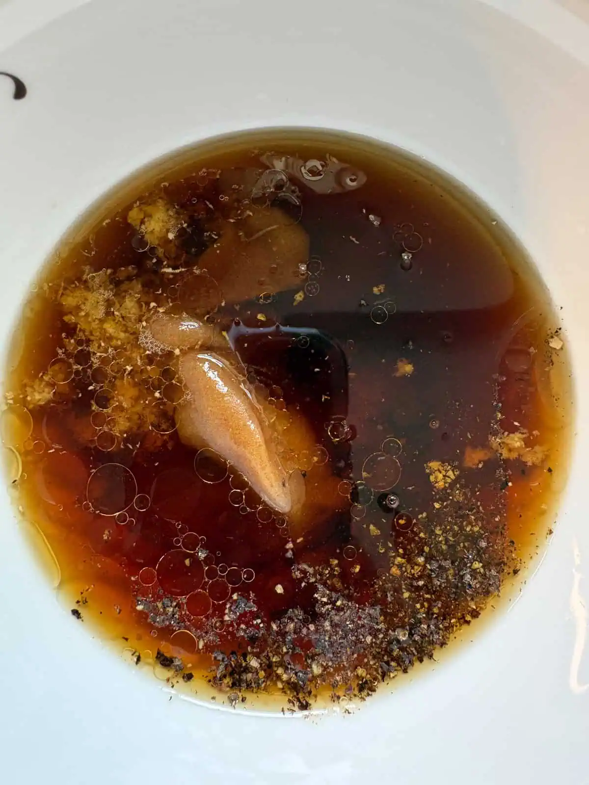 Ingredients for the teriyaki sauce added to a bowl.
