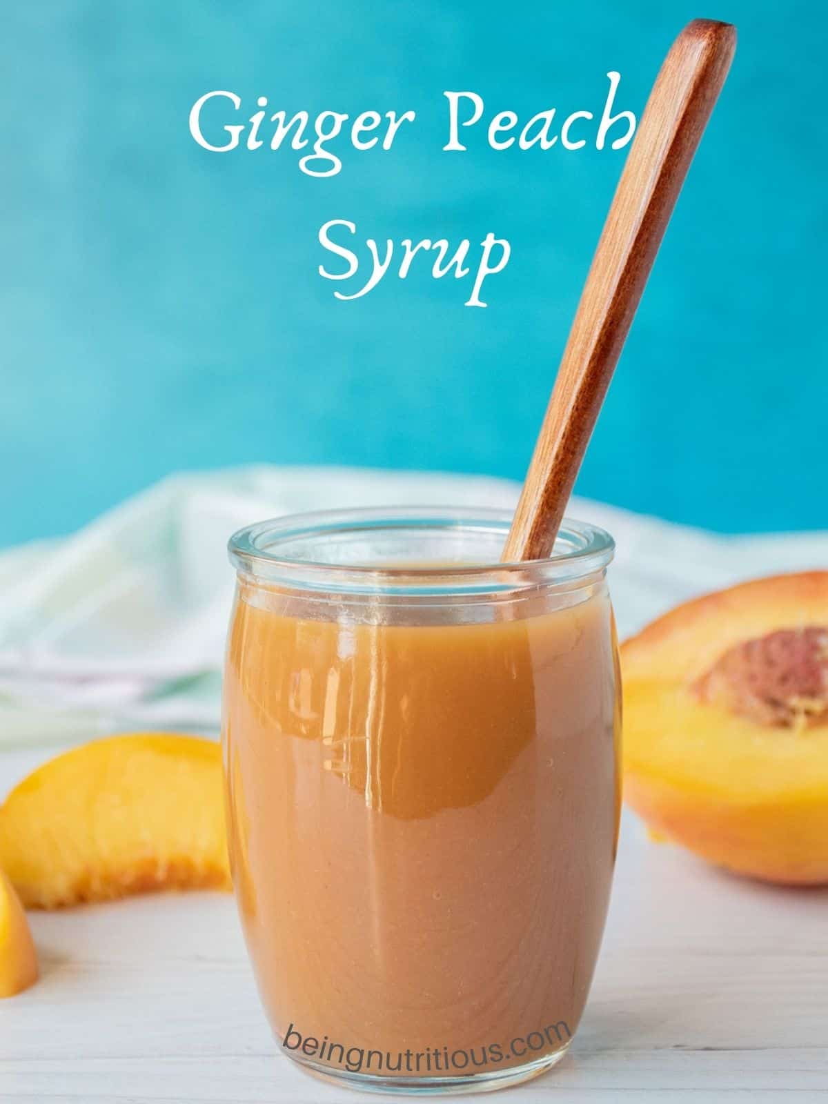 Peach sauce in a small glass jar, with peach slices surrounding. Text overlay: Ginger Peach Syrup.