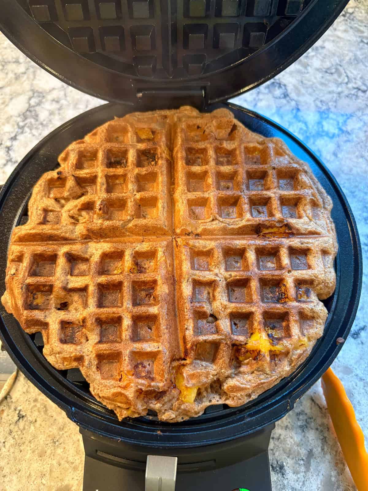 Cooked waffle in the waffle maker.