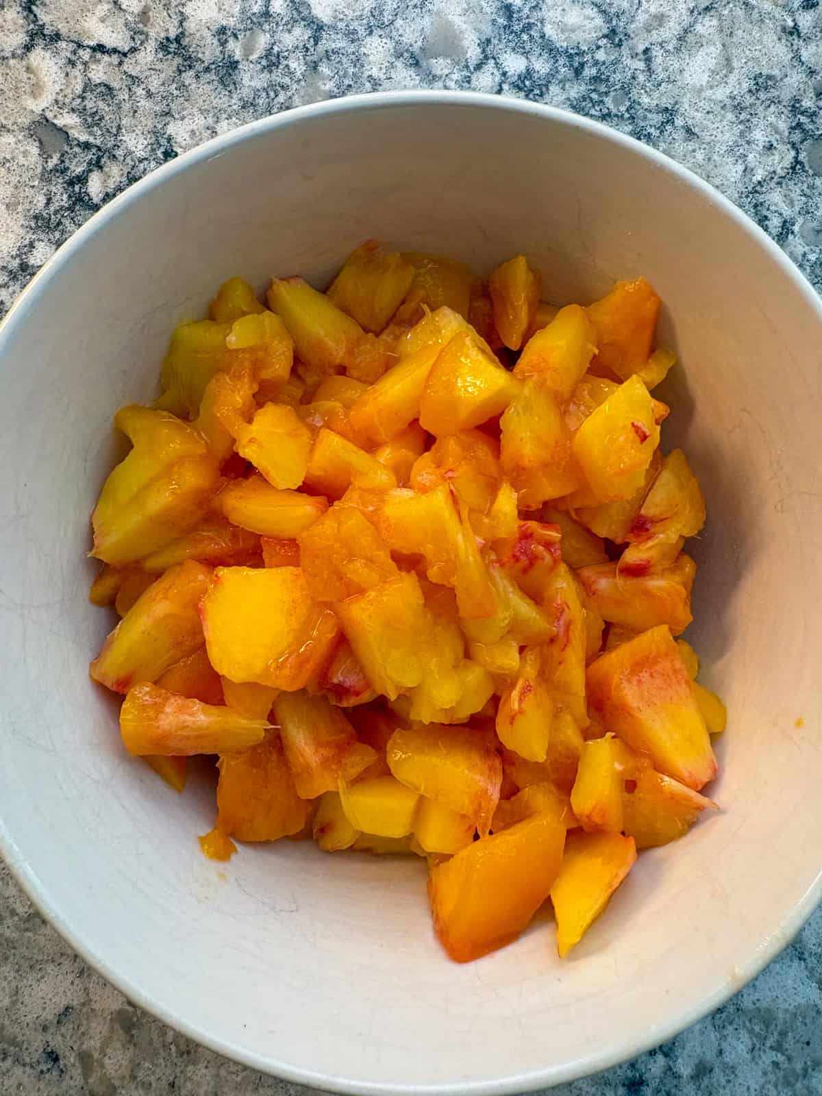 Diced peaches in a small bowl.