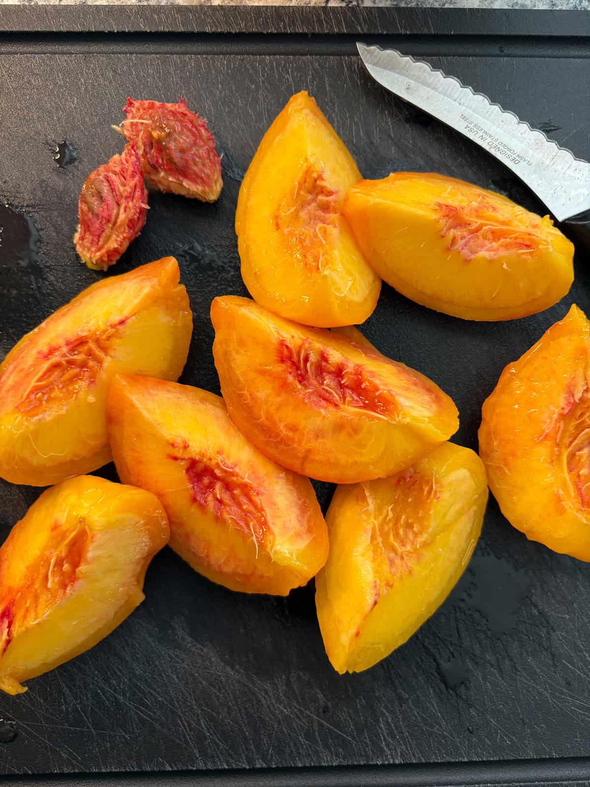 Peaches quartered, and pits removed.