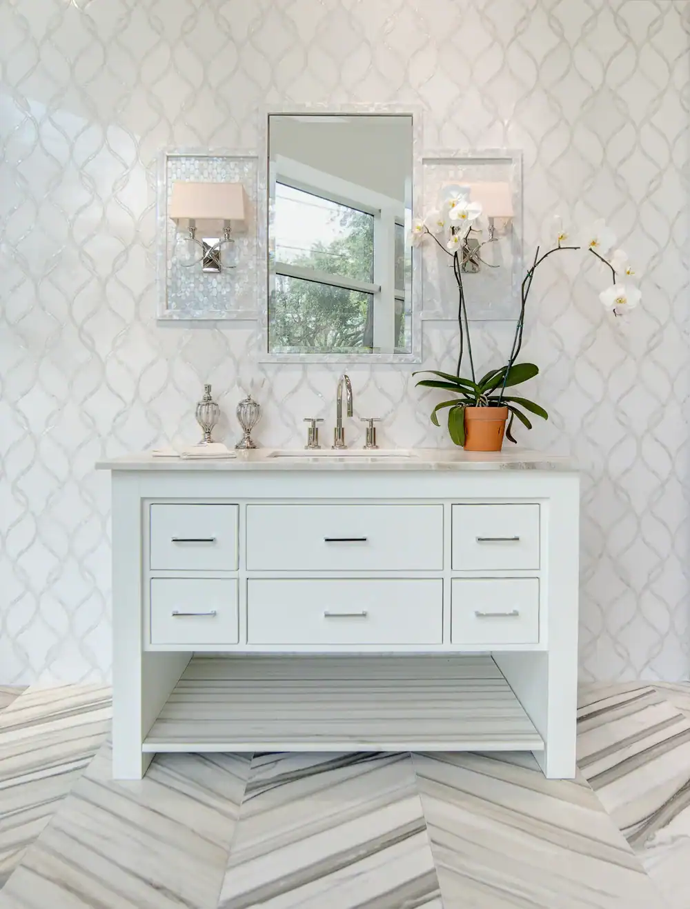 Elegant bathroom vanity with mirror and orchid in a modern interior.