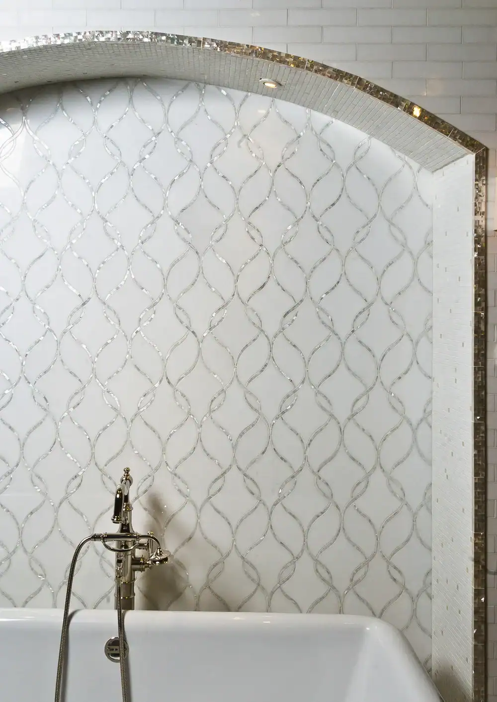 Elegant bathroom with decorative tile wall and vintage faucet.