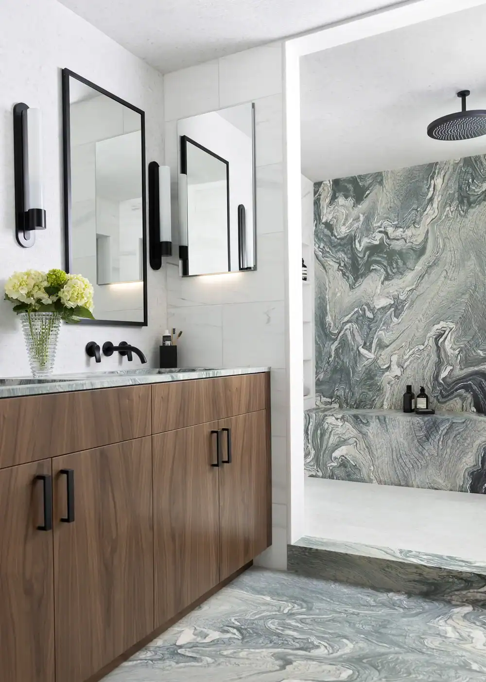 Modern bathroom with wooden vanity and marble accents.