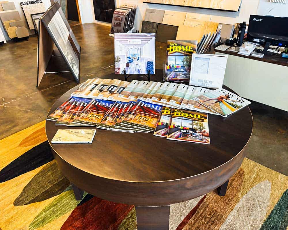 Display table with Bella Pietra Design magazines and brochures in showroom.