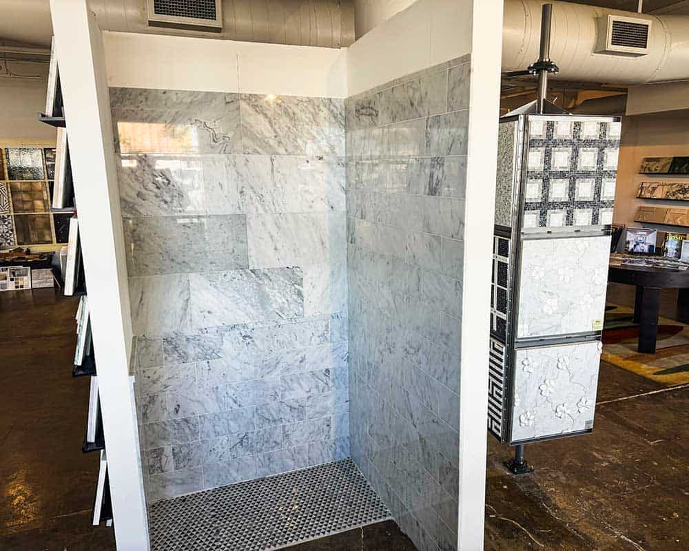Marble shower wall with sleek gray and white veining for modern bathrooms.