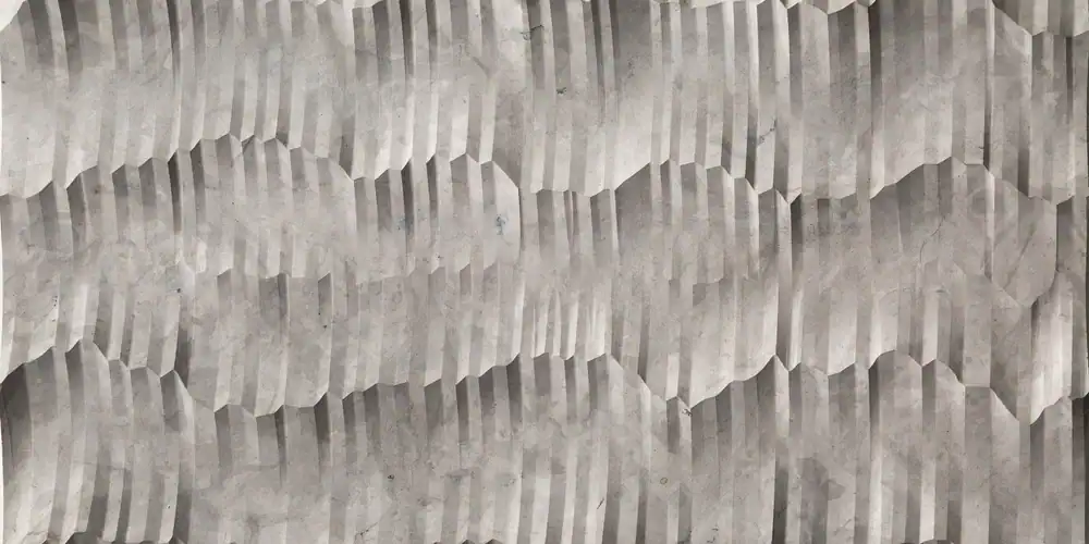 Close-up of textured gray stone surface with geometric pattern.