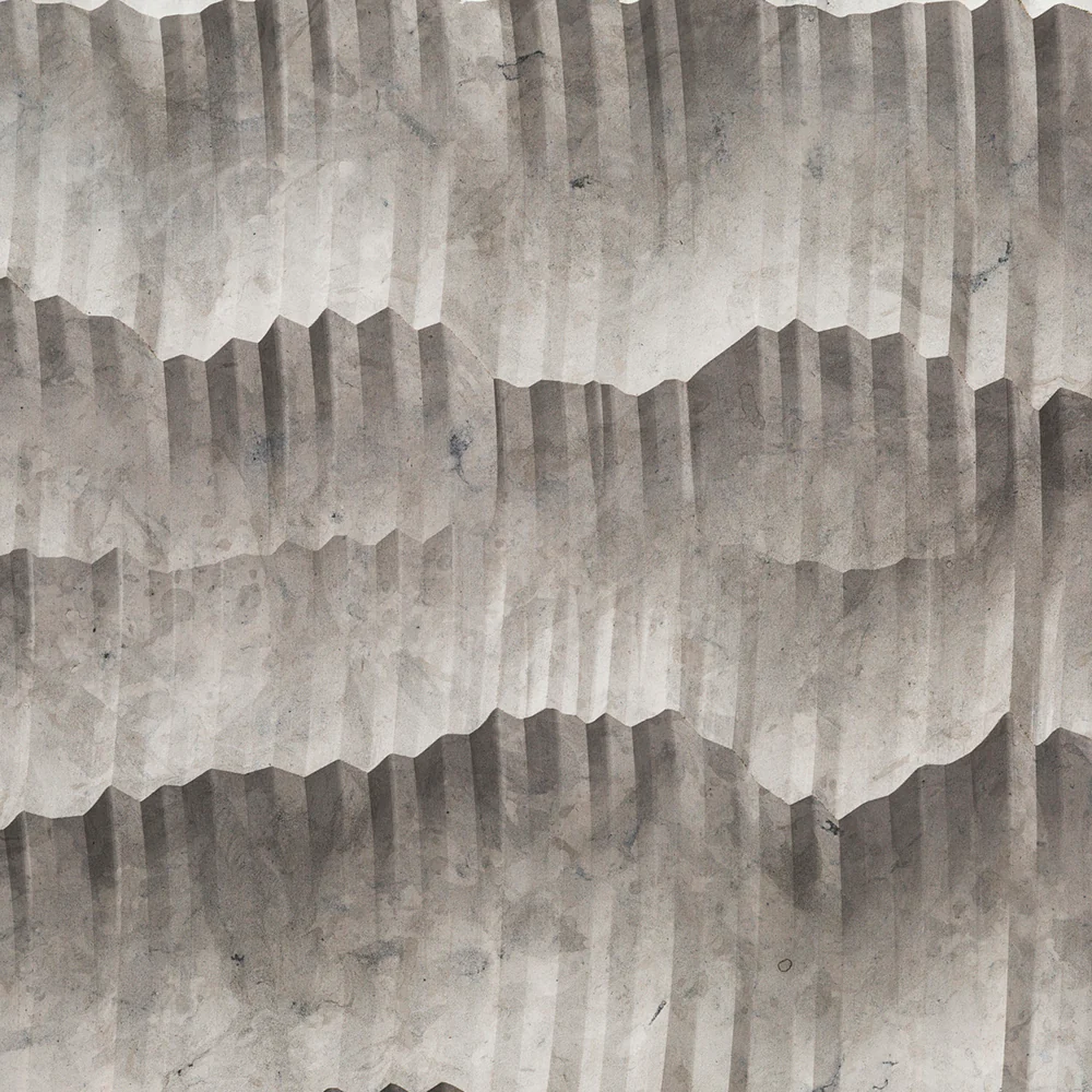 Textured concrete wall with geometric patterns in gray tones.
