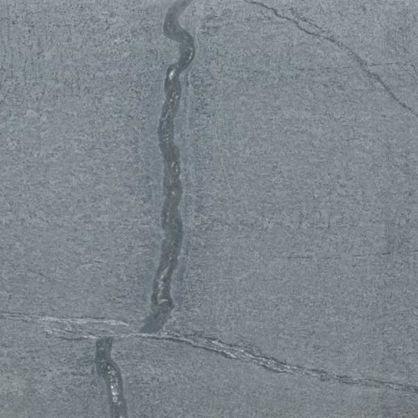 Close-up of textured gray stone surface with natural cracks.