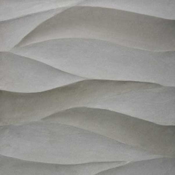 Textured white stone wall with flowing wave-like patterns.