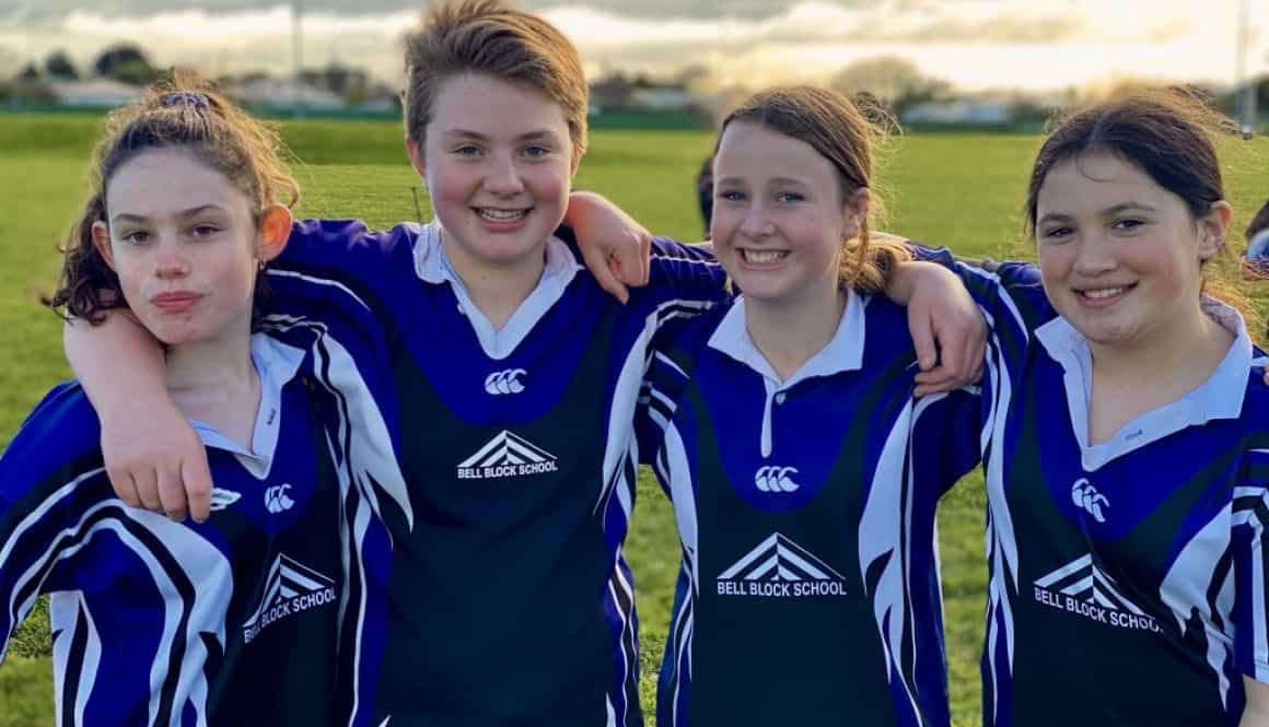 Young students in rugby uniforms at Bell Block School sports event in New Zealand.