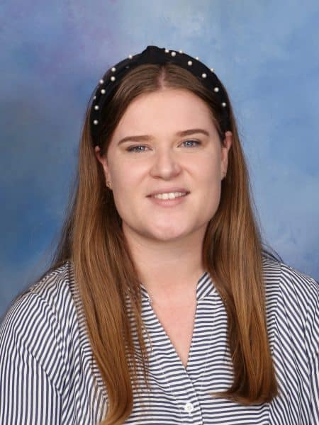 Inspired by a school portrait at Bell Block School, showcasing a student in a school uniform with a blue background.