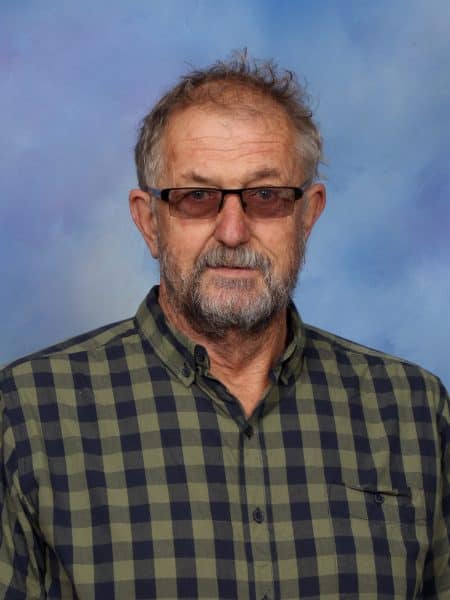 Man with glasses and a checkered shirt.