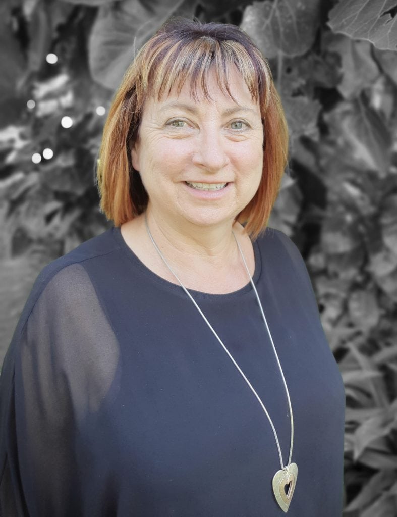 Friendly woman educator at Bell Block School smiling, outdoors.