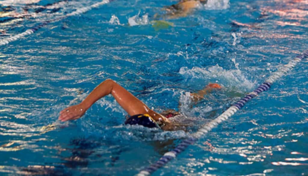 Competitive swimming training at Bell Block School pool, emphasizing aquatic sports for students.