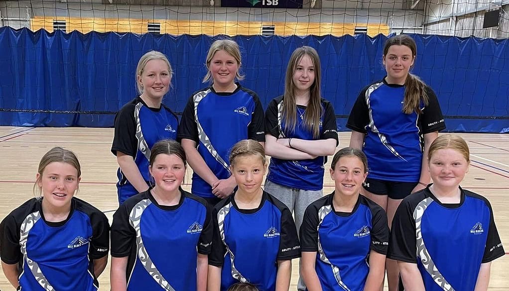 Bell Block School netball team in sports uniforms inside gymnasium, representing primary school sports.