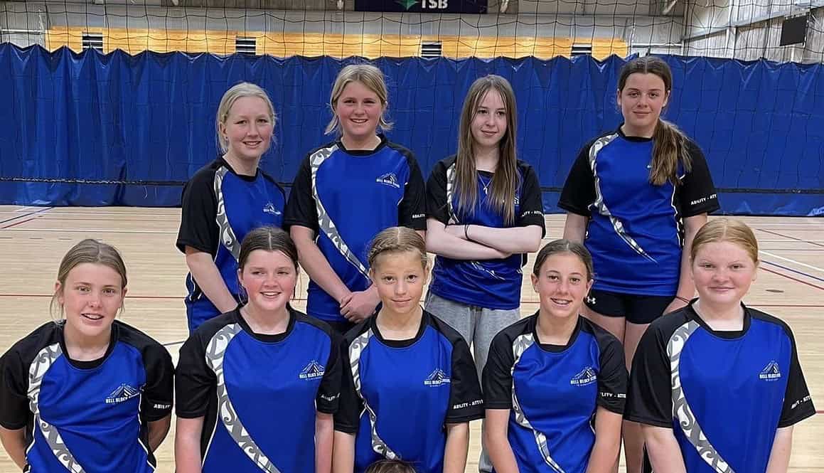 Bell Block School netball team in sports uniforms inside gymnasium, representing primary school sports.