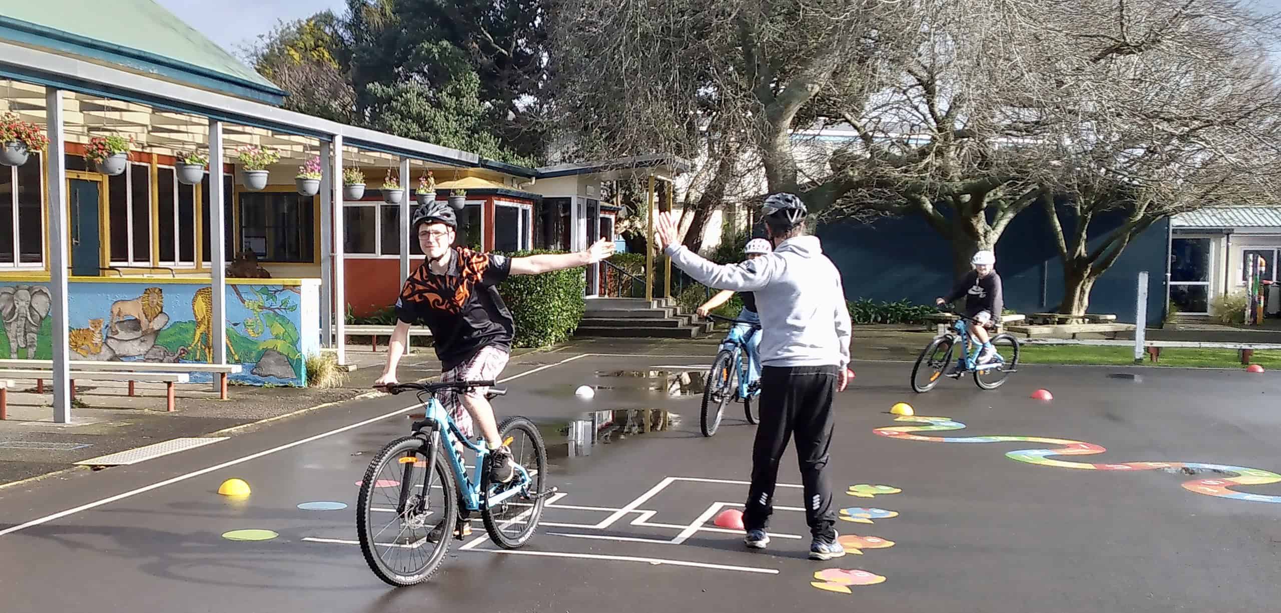 20230725_105043 Bike safety training at Bell Block School in New Zealand, kids learning cycling skills, outdoor school activity with helmets.