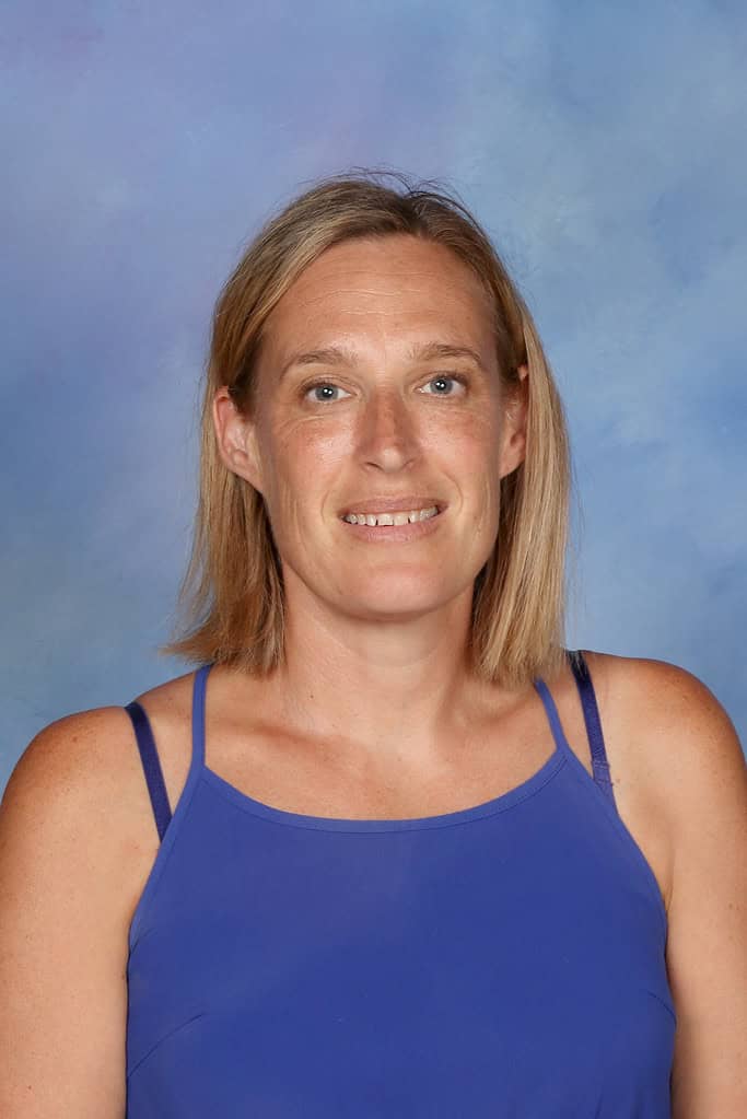 Teacher at Bell Block School, New Zealand, smiling in school uniform.