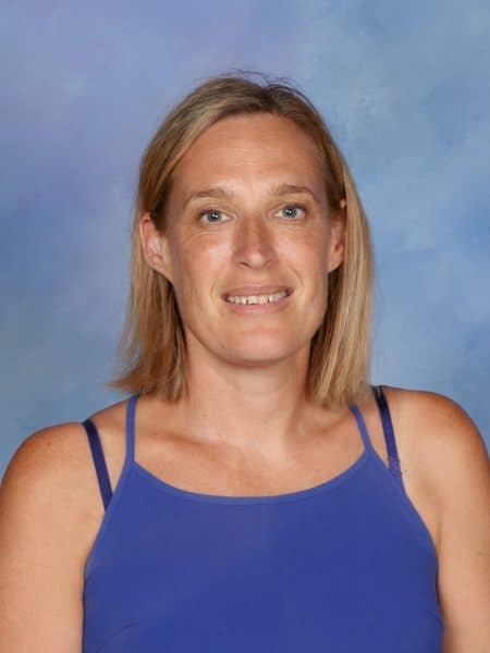 Teacher at Bell Block School, New Zealand, smiling in school uniform.