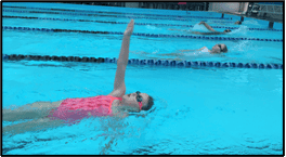 Swimming pool swimmer performing backstroke at Bell Block School swimming lesson.