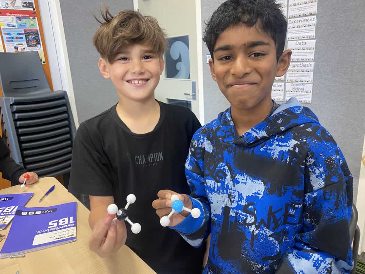 Atom model science activity at Bell Block School, students engaged in hands-on learning.