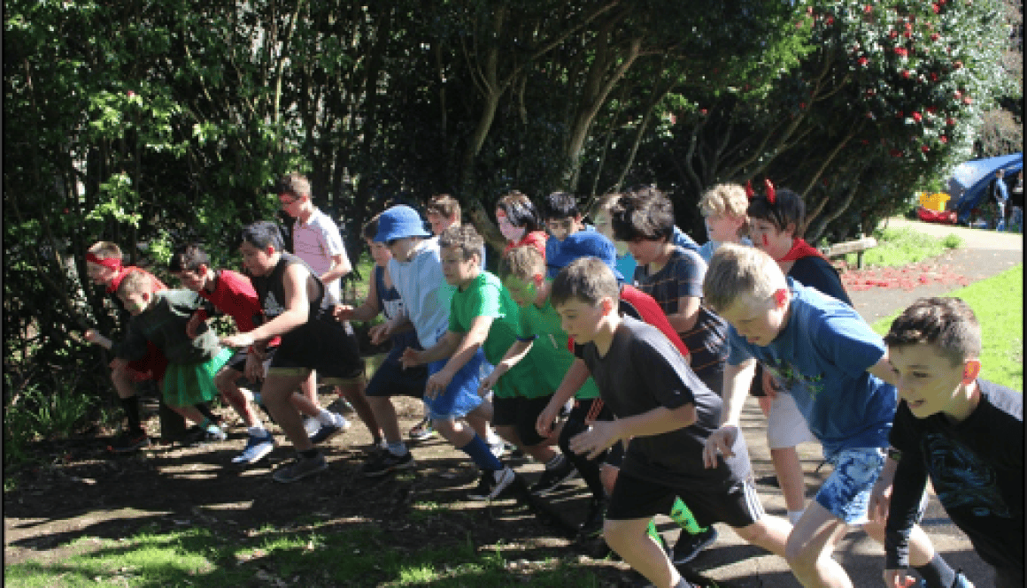 Children outdoors engaging in a race at Bell Block School, NZ, during a school sports event.