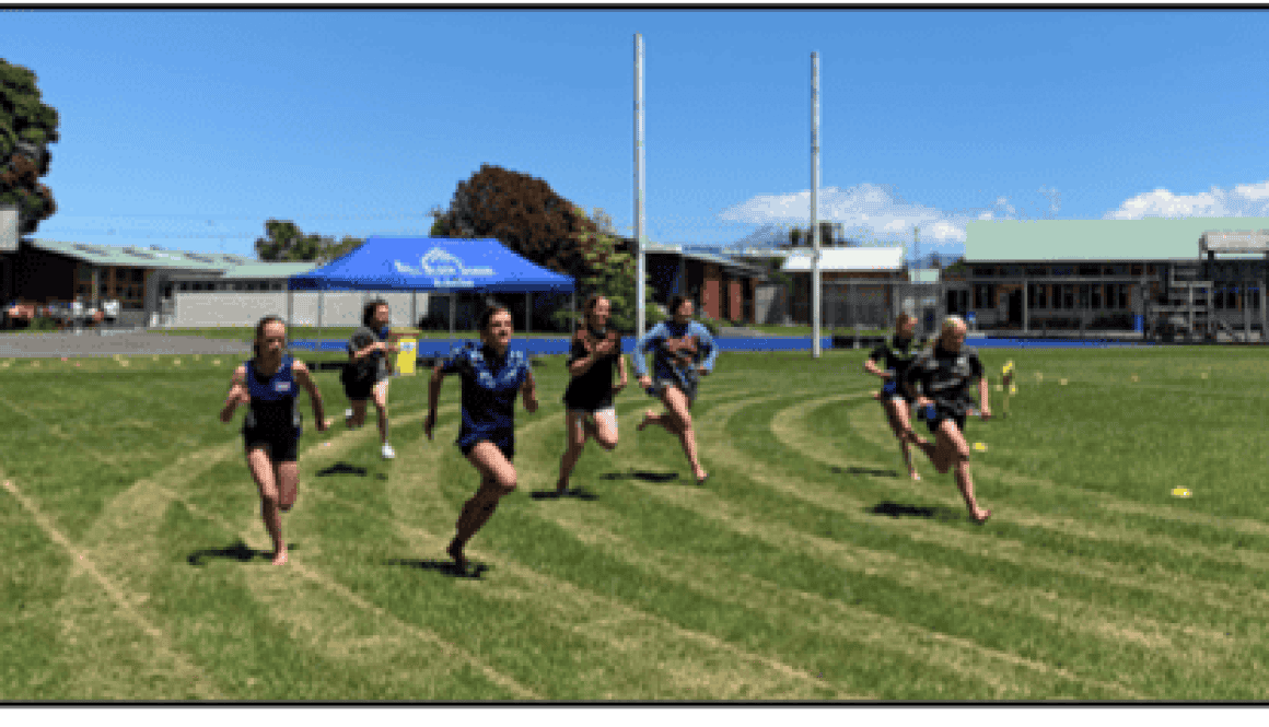 Students running on the sports field at Bell Block School, New Zealand, during a physical education class.