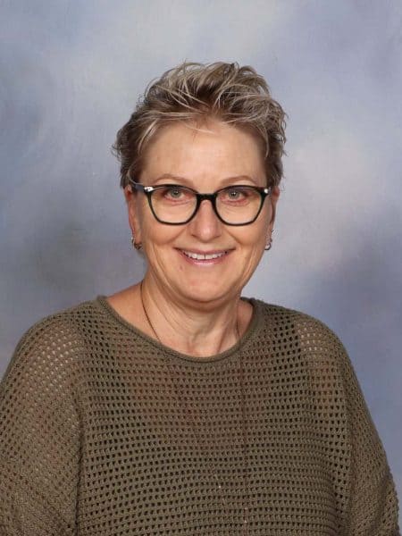 Experienced teacher smiling at Bell Block School, New Zealand.