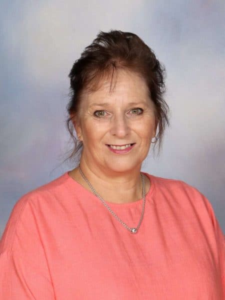 Smiling woman teacher at Bell Block School, a supportive primary school in New Zealand dedicated to student excellence.