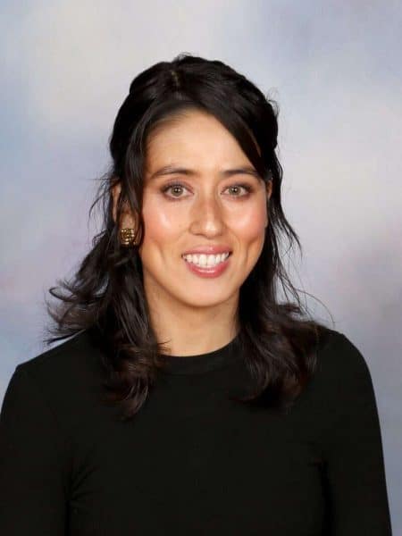 Professional woman smiling for the camera at Bell Block School in New Zealand - friendly educator portrait.
