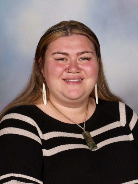 Warm smiling woman at Bell Block School, New Zealand, showcasing friendly environment.