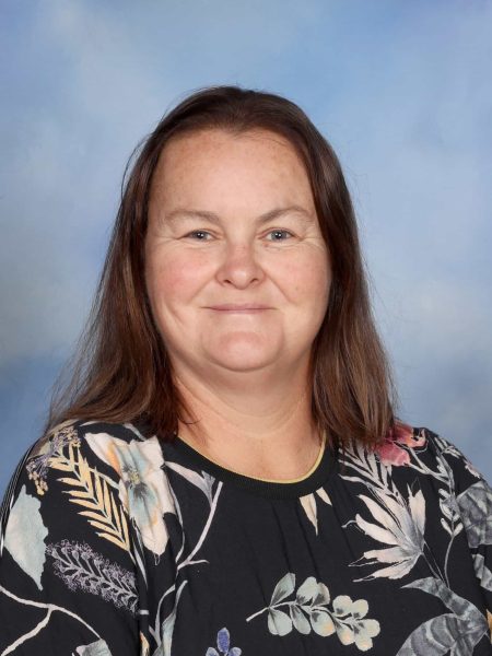 Rachel Marshall-Smith, a dedicated teacher at Bell Block School, standing confidently in front of a.