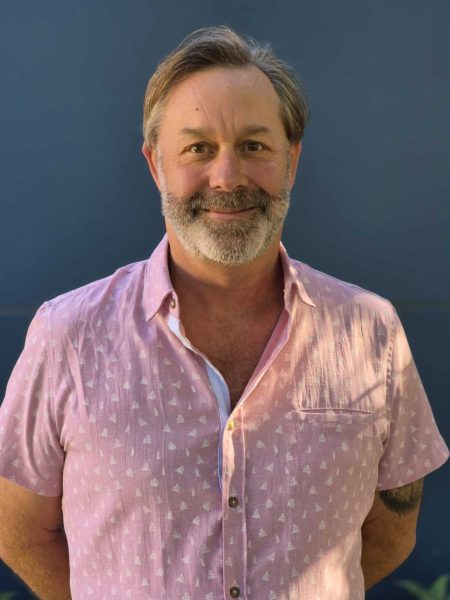 Portrait of a smiling male staff member at Bell Block School, New Zealand.