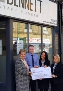 Bennett Staff team presenting donation outside the office in 2018-2019.