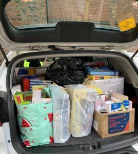 Car trunk filled with donations for charity collection.