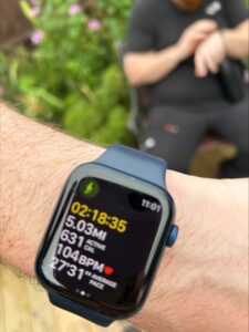 Hiking smartwatch displaying distance, pace, and heart rate during outdoor walk.