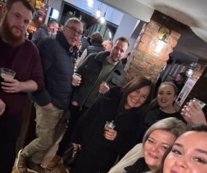 Group of colleagues enjoying drinks at Bennett Staff gathering.