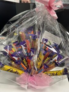 Bright gift basket with chocolate bars and treats for special occasions.