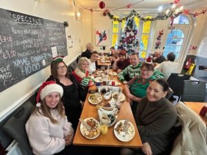 Staff enjoying Christmas meal at Bennett Staff in festive setting.