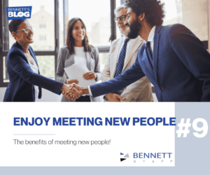 Business professionals shaking hands during a meeting in an office.