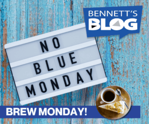 Image showing a lightbox with "NO BLUE MONDAY" and a coffee cup on a wooden surface.