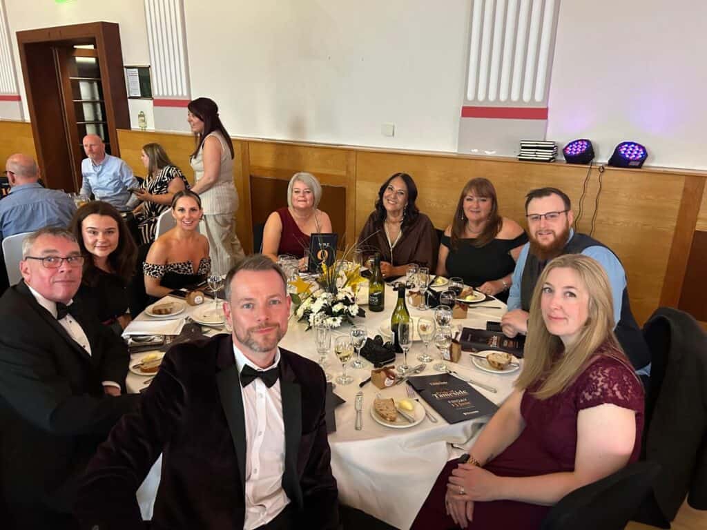 Celebrating the SME of the Year Award 2025 with a group of professionals at a formal event.