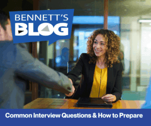 Smiling woman in a blazer shakes hands across a table, conveying a friendly interview setting. Text: "Bennett's Blog: Common Interview Questions & How to Prepare."