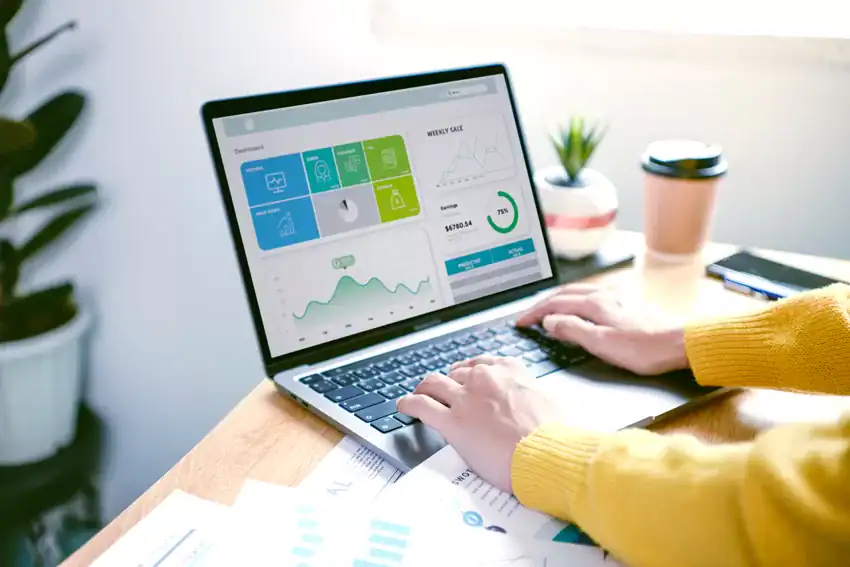 Cloud-based business management software interface on a laptop for Indonesian businesses.