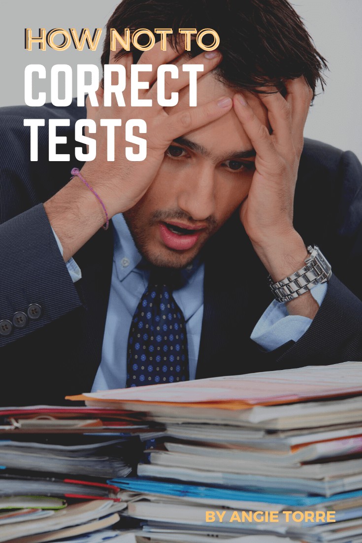 How Not to Correct Tests: Teacher overwhelmed looking at a pile of papers